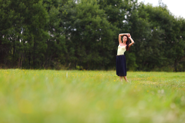 Woman on green grass field - Фото, зображення