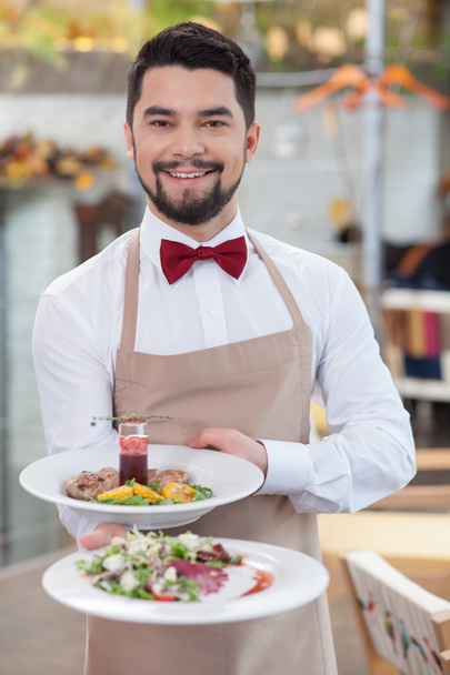 Handsome young waiter is working in restaurant - Zdjęcie, obraz