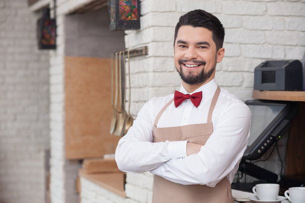 Handsome young waiter is working with joy - Photo, Image