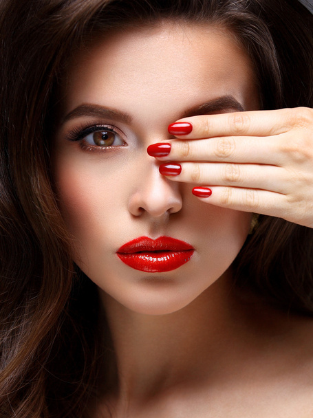 Red Sexy Lips and Nails closeup. Open Mouth. Manicure and Makeup. Make up concept. Half of Beauty model girls face isolated on black background - Фото, зображення