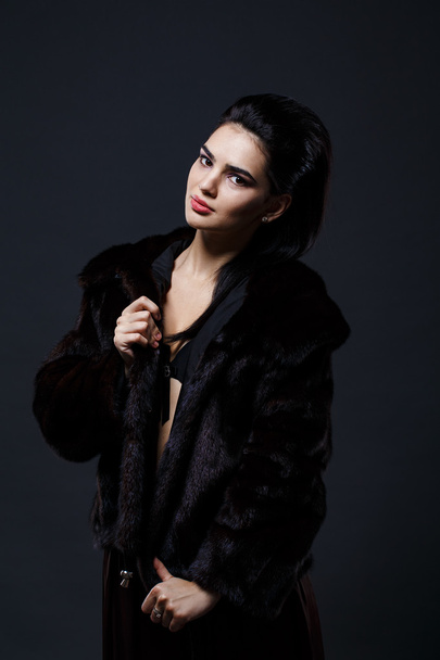 Portrait of a seductive lady in fur coat - 写真・画像