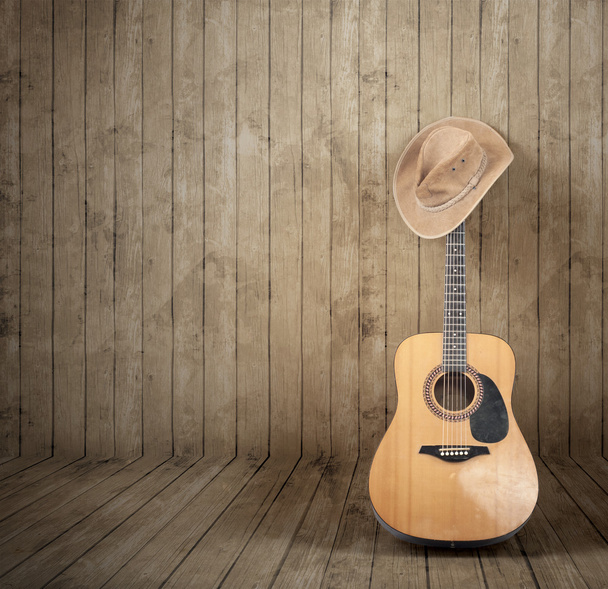 Sombrero de vaquero y guitarra
  - Foto, Imagen