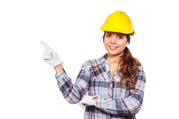 Young woman in construction helmet and check shirt - Фото, зображення