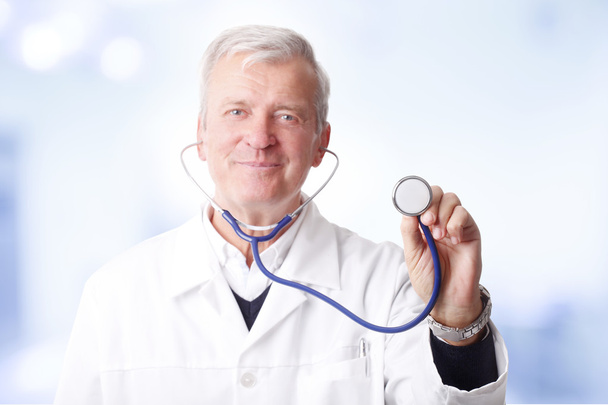 doctor holding a stethoscope up - Foto, afbeelding
