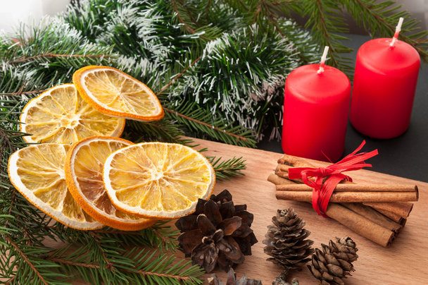 Christmas composition - candle, cones, dried orange, cinnamon, fir tree branch. - Valokuva, kuva