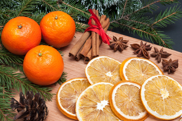 Christmas composition - cones, orange, anise, cinnamon, fir tree branch. - Photo, Image