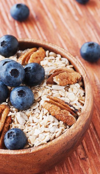 oat meal with walnuts and blueberries selective focus - Photo, Image