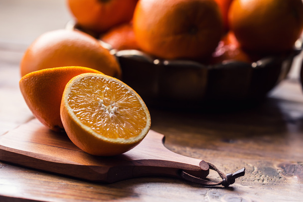 Fresh oranges. Cut oranges. Pressed orange manual method. Oranges and sliced oranges with juice and squeezer - Fotó, kép