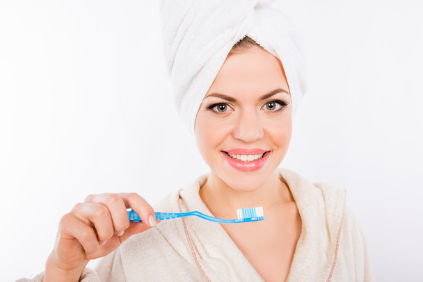Young beautiful girl brushing teeth with toothbrush on white bla - Фото, изображение