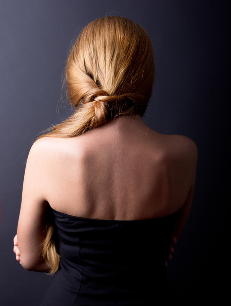 Beautiful female spin on a black background. Back pain. Cervical Spine. Beautiful Girl stands back. - Photo, Image