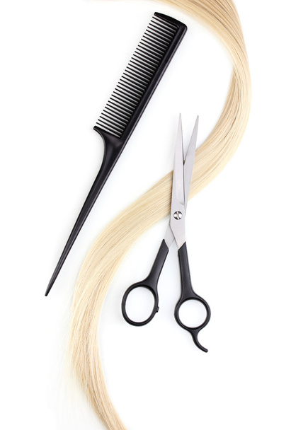 Shiny blond hair with hair cutting shears and comb isolated on white - Φωτογραφία, εικόνα