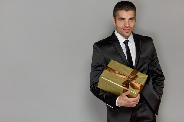 young handsome man with a gift - Photo, Image
