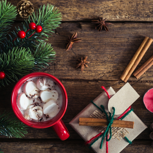 red cup with cocoa and marshmallows on wooden background - 写真・画像