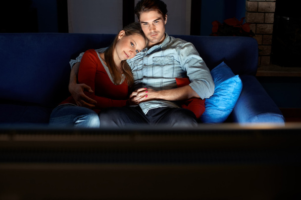 Мужчина и женщина смотрят кино по телевизору
 - Фото, изображение
