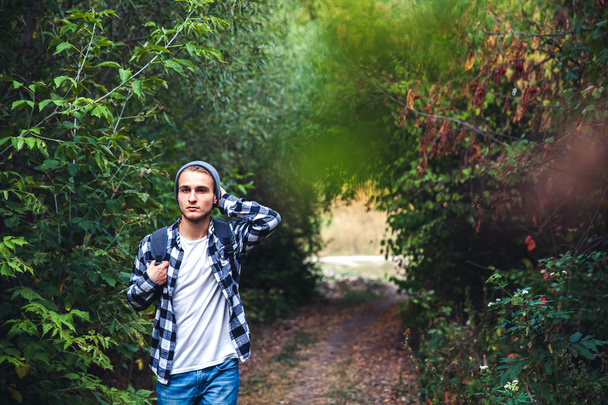 Portrait of young handsome man with backpack wanderer walk in the woods - Foto, Imagem