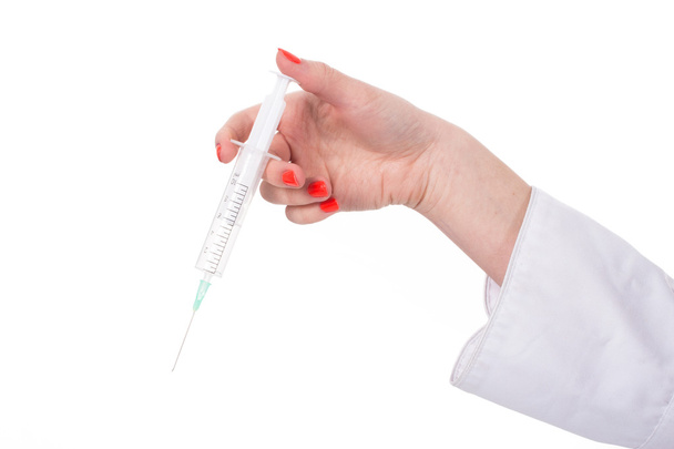 Hand brings syringe - Фото, изображение