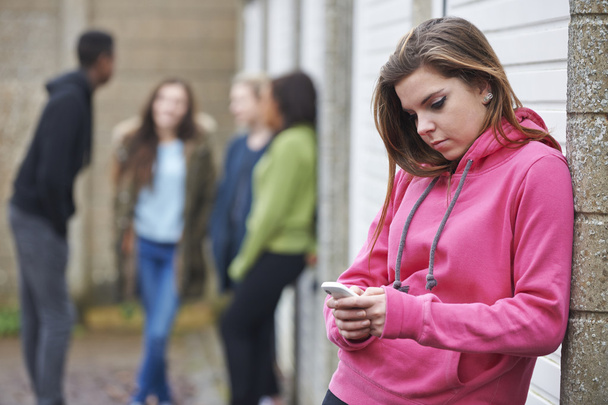 Teenage Girl Using Mobile Phone In Urban Setting - 写真・画像