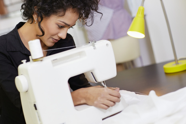 Fashion designer with sewing machine - Photo, Image