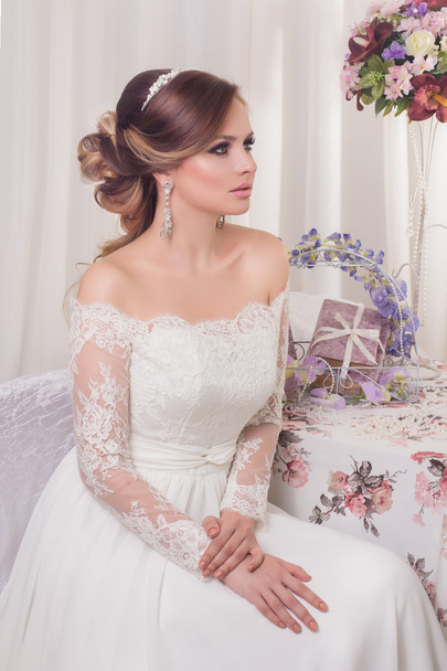 Beauty woman with wedding hairstyle and makeup. Bride fashion. Jewelry and Beauty. Woman in white dress,perfect skin. Girl with stylish haircut. - Φωτογραφία, εικόνα