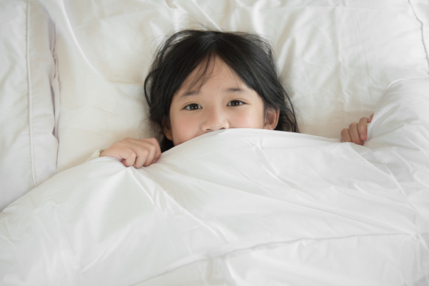 Aranyos ázsiai childrplaying-ágyon - Fotó, kép