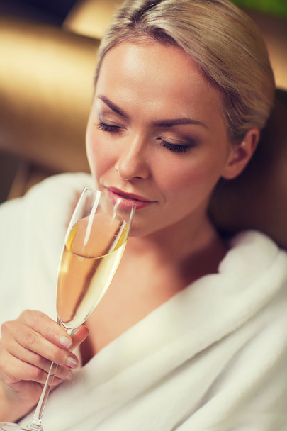 beautiful young woman drinking champagne at spa - Zdjęcie, obraz