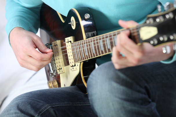 Closeup of a man playing a guitar - Фото, зображення