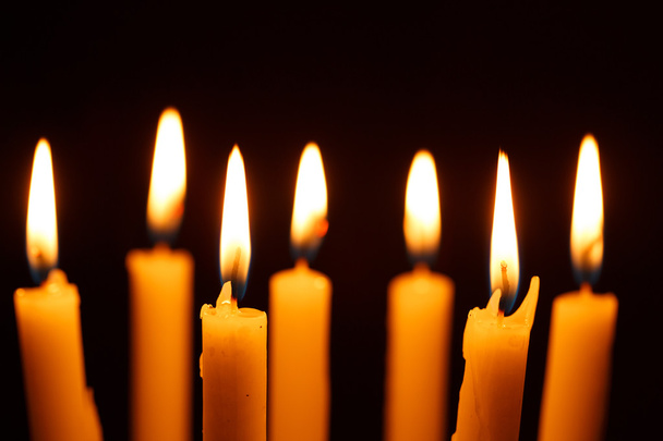 Many burning candles on black - Фото, изображение