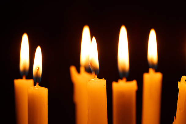 Many burning candles on black - Foto, Imagen