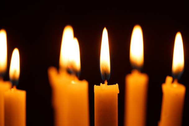 Many burning candles on black - 写真・画像