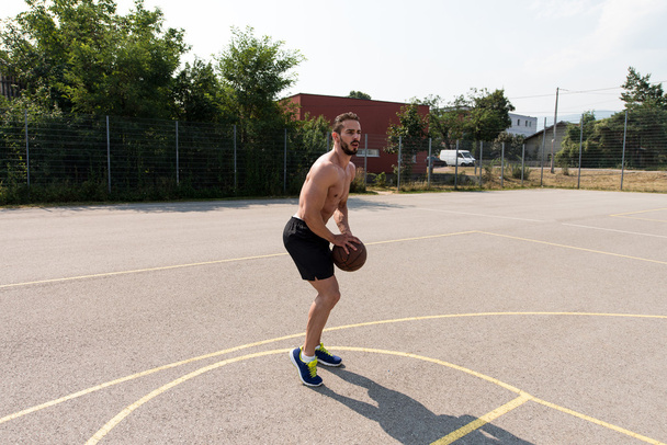 Bodybuilder Playing Basketball Outdoor - Photo, image