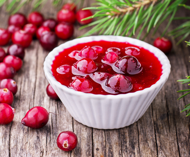 sauce of wild organic cranberries on a wooden table with berries  - 写真・画像