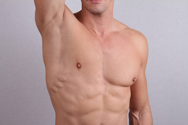 Close up of muscular male torso, chest and armpit hair removal. Male Waxing - Фото, изображение