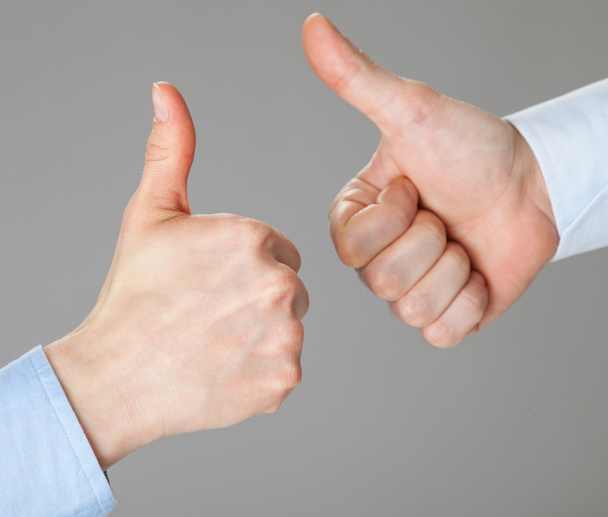 Businessmen gesturing thumbs up - Foto, imagen