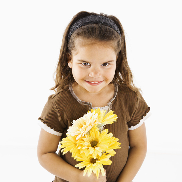 Cute little hispanic girl with bouquet. - Фото, зображення