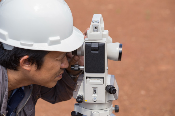 Engineers use tacheometer or theodolite for survey line columns  - Photo, Image