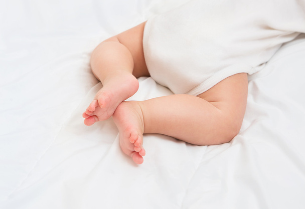 Newborn Baby legs on the bed - Fotó, kép