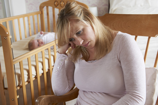Mother In Nursery Suffering From Post Natal Depression - 写真・画像