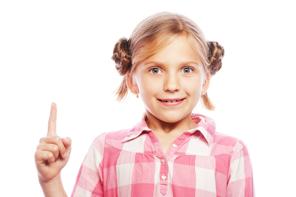 Pretty school girl pointing her index finger upwards in exciteme - Fotoğraf, Görsel
