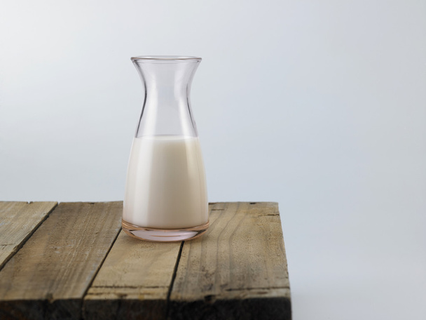 Fresh milk on wooden table - Фото, зображення