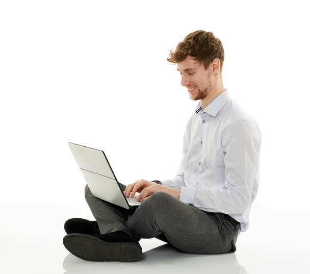 Businessman with laptop on white background - Фото, изображение