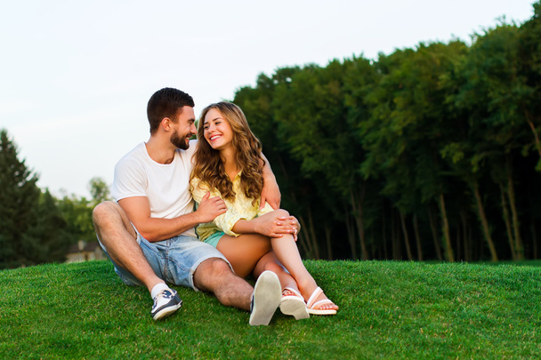Guy and girl hugging and smile in the park. - 写真・画像