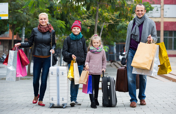 Family of tourists carrying shopping bags  - Fotó, kép