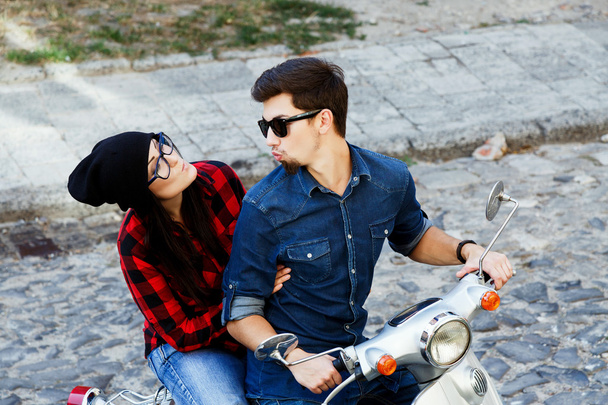 Couple riding on a vintage scooter - Photo, Image