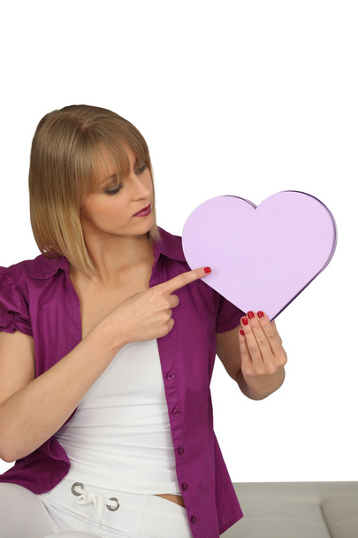 Woman pointing to a heart-shaped box - Foto, Bild