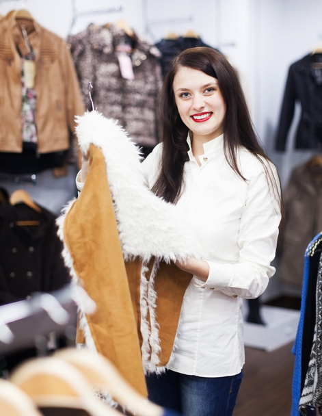 woman choosing jacket at fashion boutique - Φωτογραφία, εικόνα