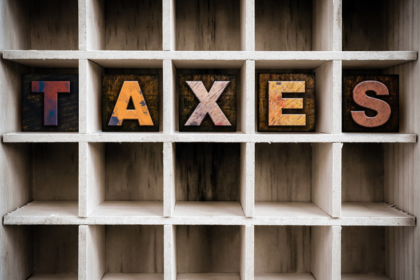 Taxes Concept Wooden Letterpress Type in Drawer - 写真・画像