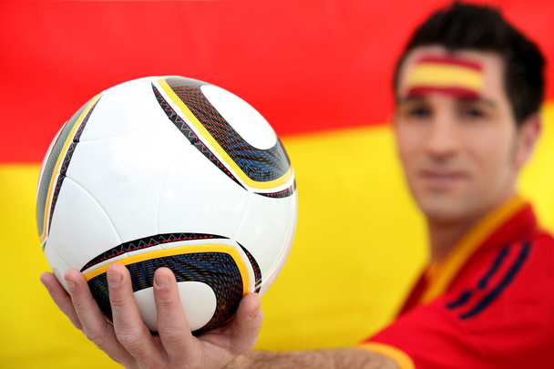 Football supporter holding soccer ball - Foto, imagen