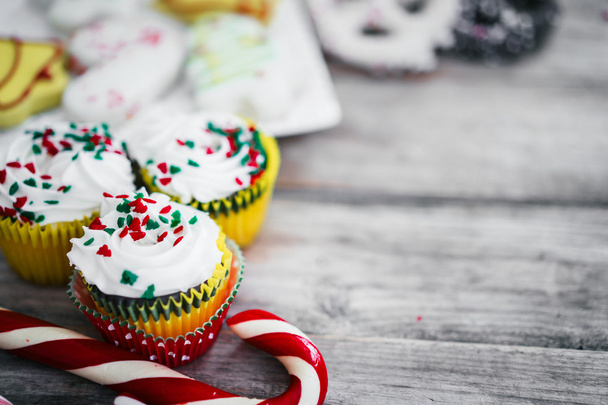 Christmas cupcakes on wooden background - Фото, изображение