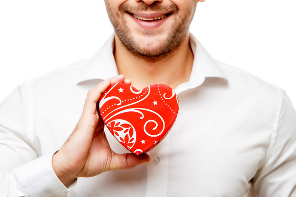 Young man carries heart shaped box - Foto, imagen