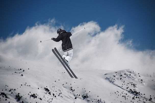 Flying skier on mountains. Extreme sport. - 写真・画像